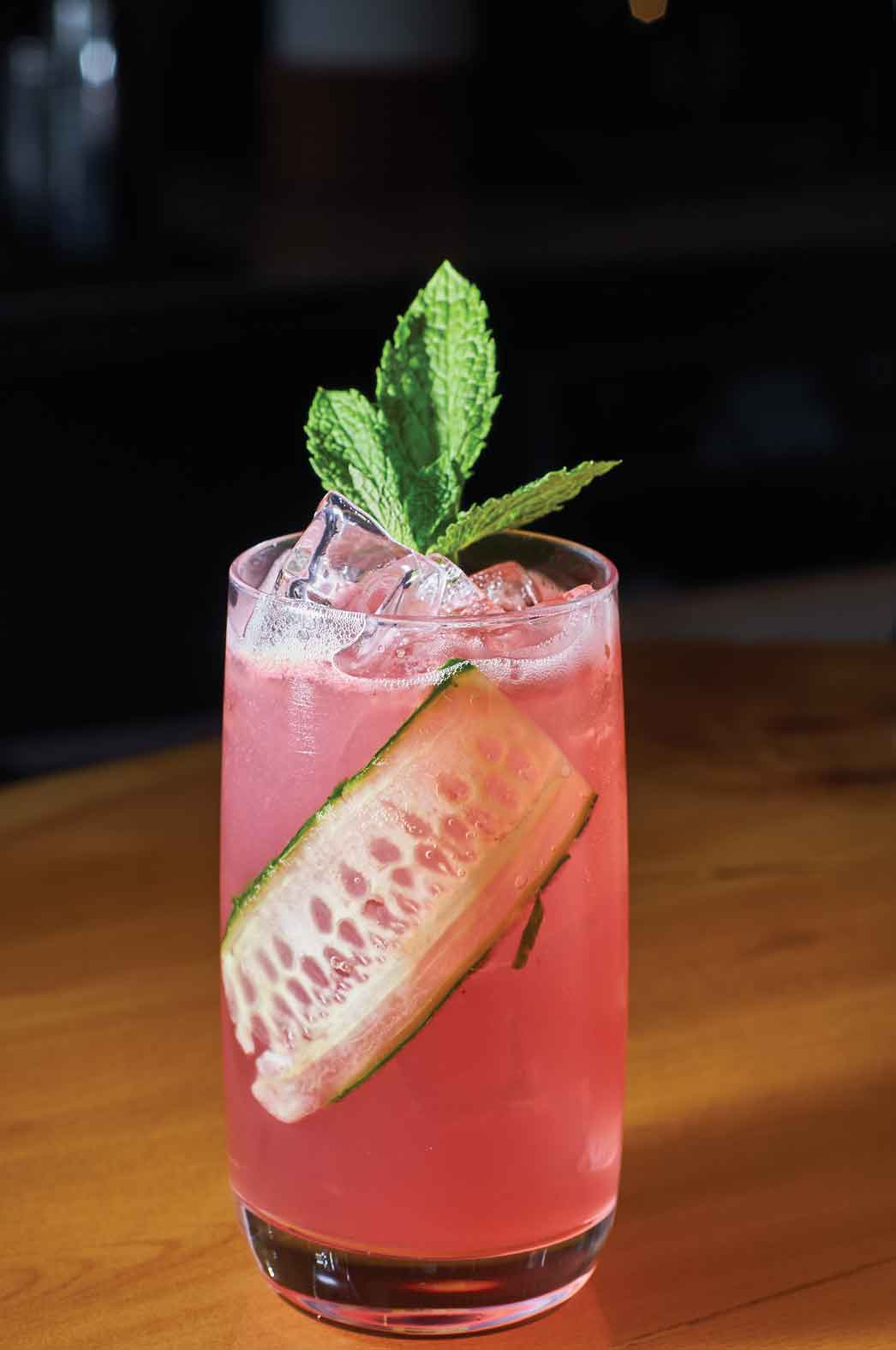 The Stairway to Heaven is a unique summer cocktail made with fresh mint and a slice of cucumber. The green and pink drink is sweet and summery. Photo by Damian Lamartine