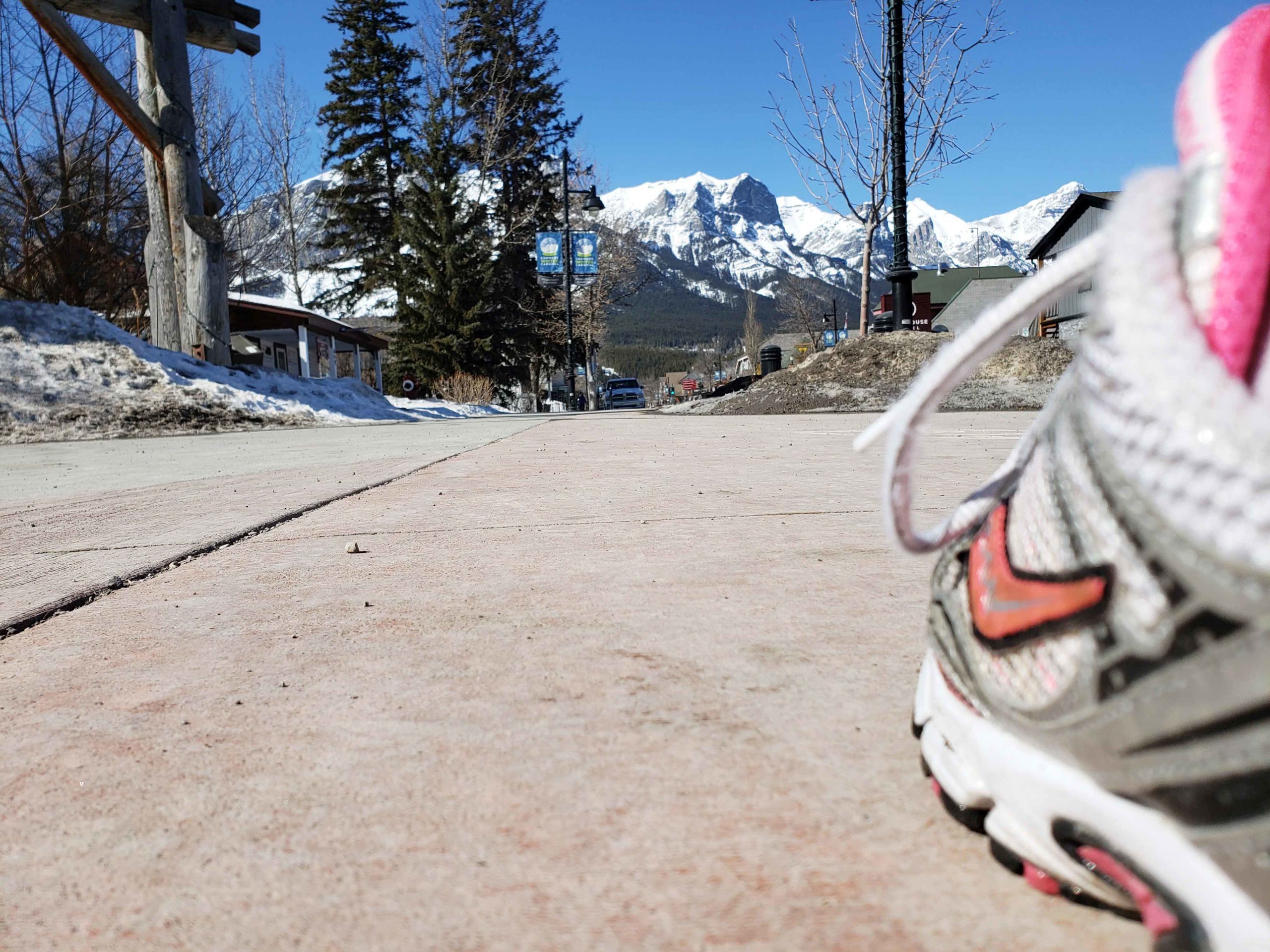 Running shoe on Main Street, Canmore with no one around. Taken for the Strides Virtual Challenge