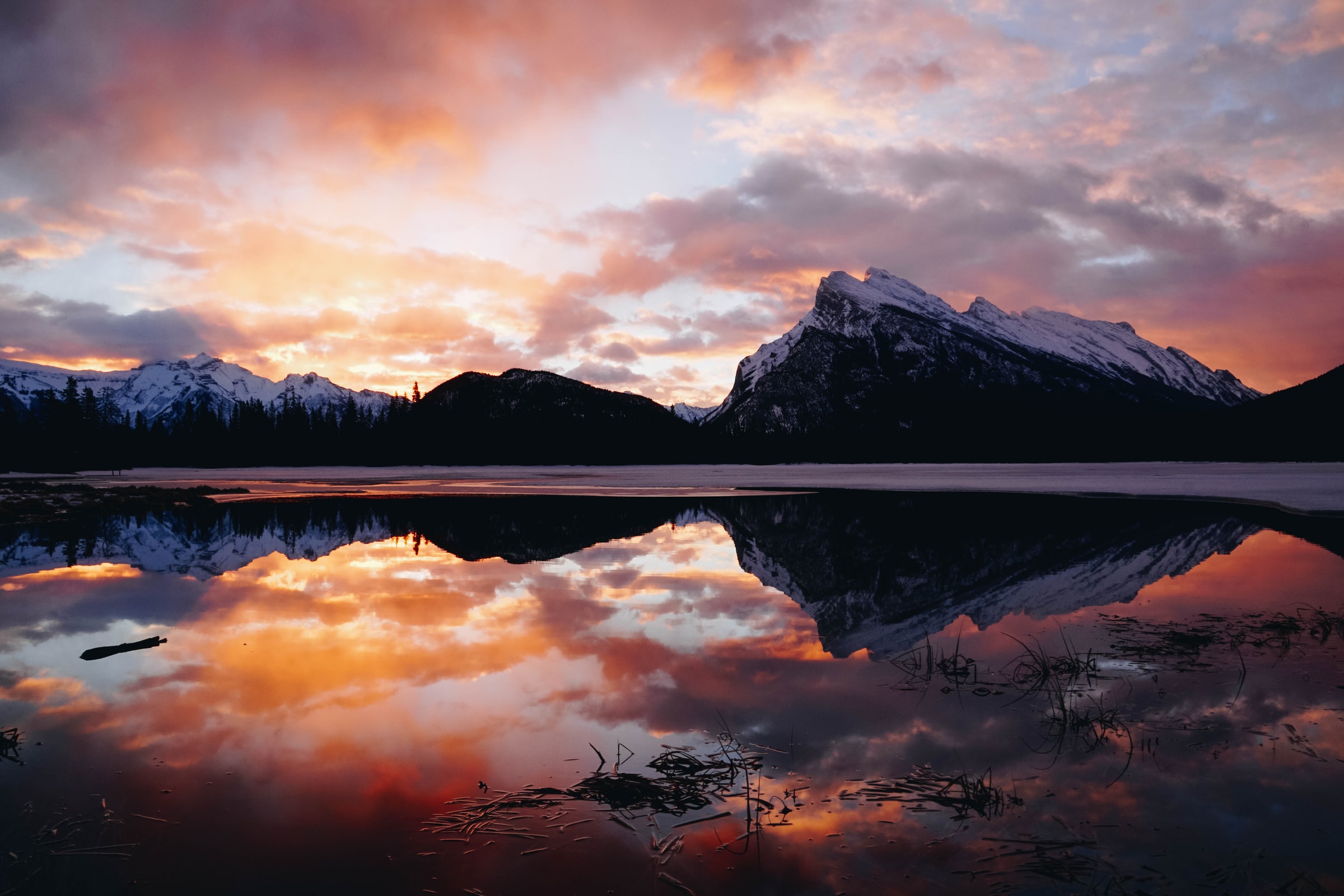 The iconic Rundle Mountain reflecting in Vermillion Lakes during a colourful sunset is an iconic Canadian Rockies photograph