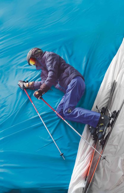 An alpine skier on a blue and white background