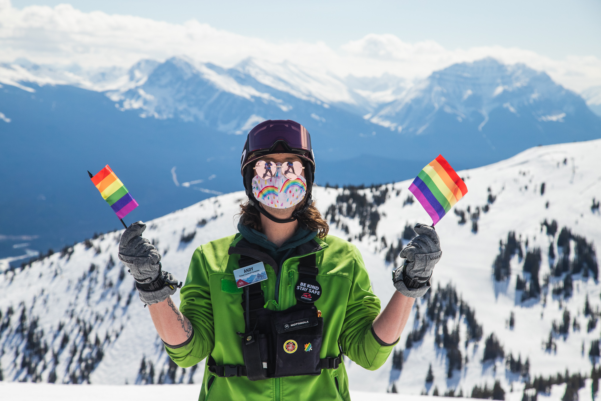 A person holding pride flags at Marmot Basin Ski Resort