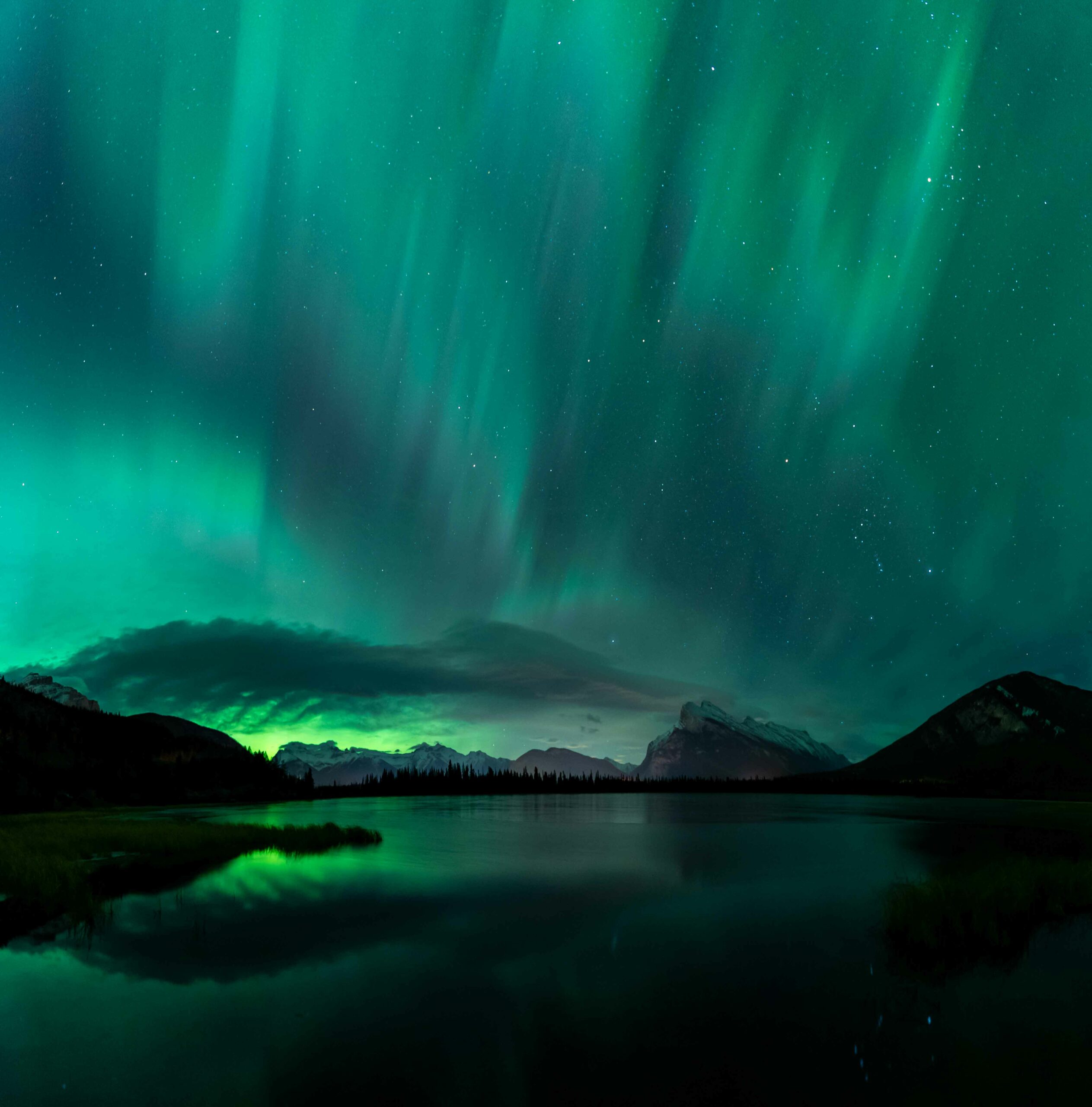 A green wave of Northern Lights reflected in the lake
