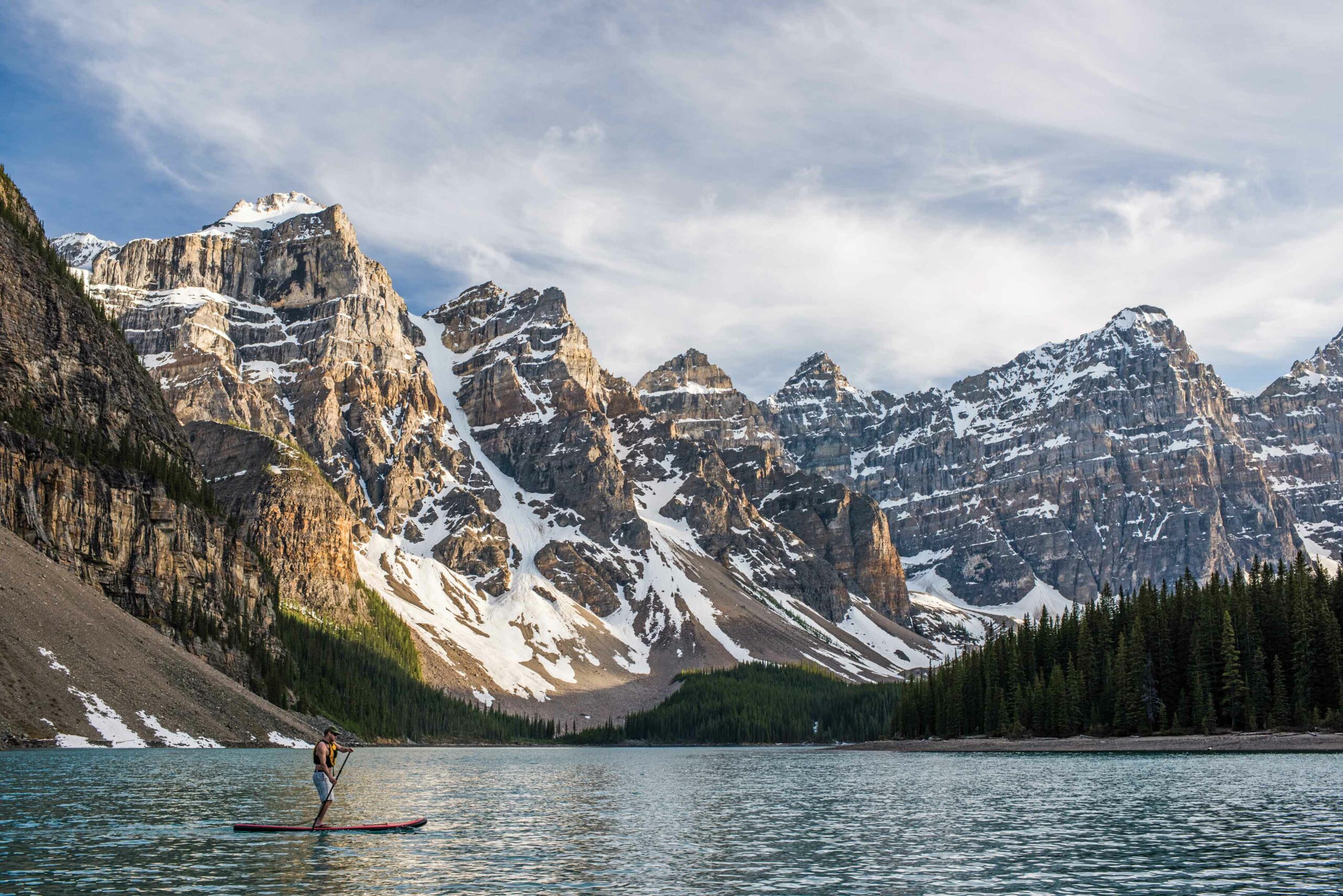 A person on a paddle board at Moraine Lake. This year, the only way to access this spot in the Canadian Rockies is by public transit. 