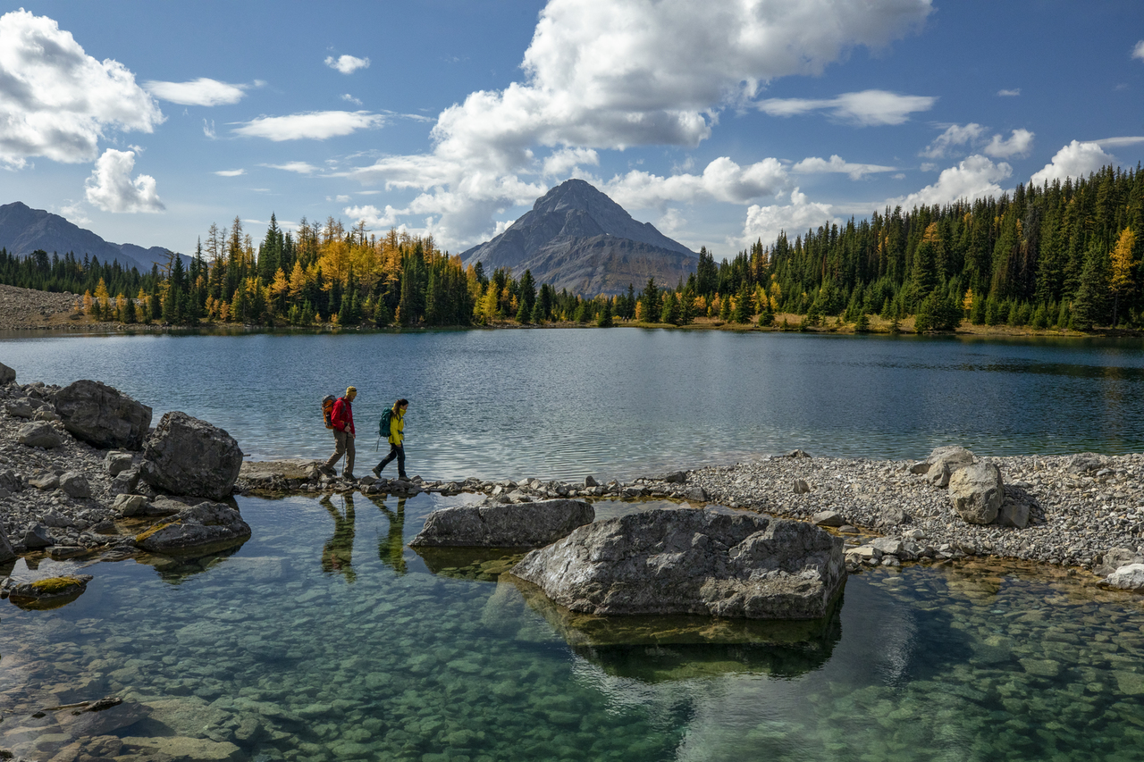 Two people hike at Chester Lake in the fall. This is one of the great shorter Kananaskis hikes