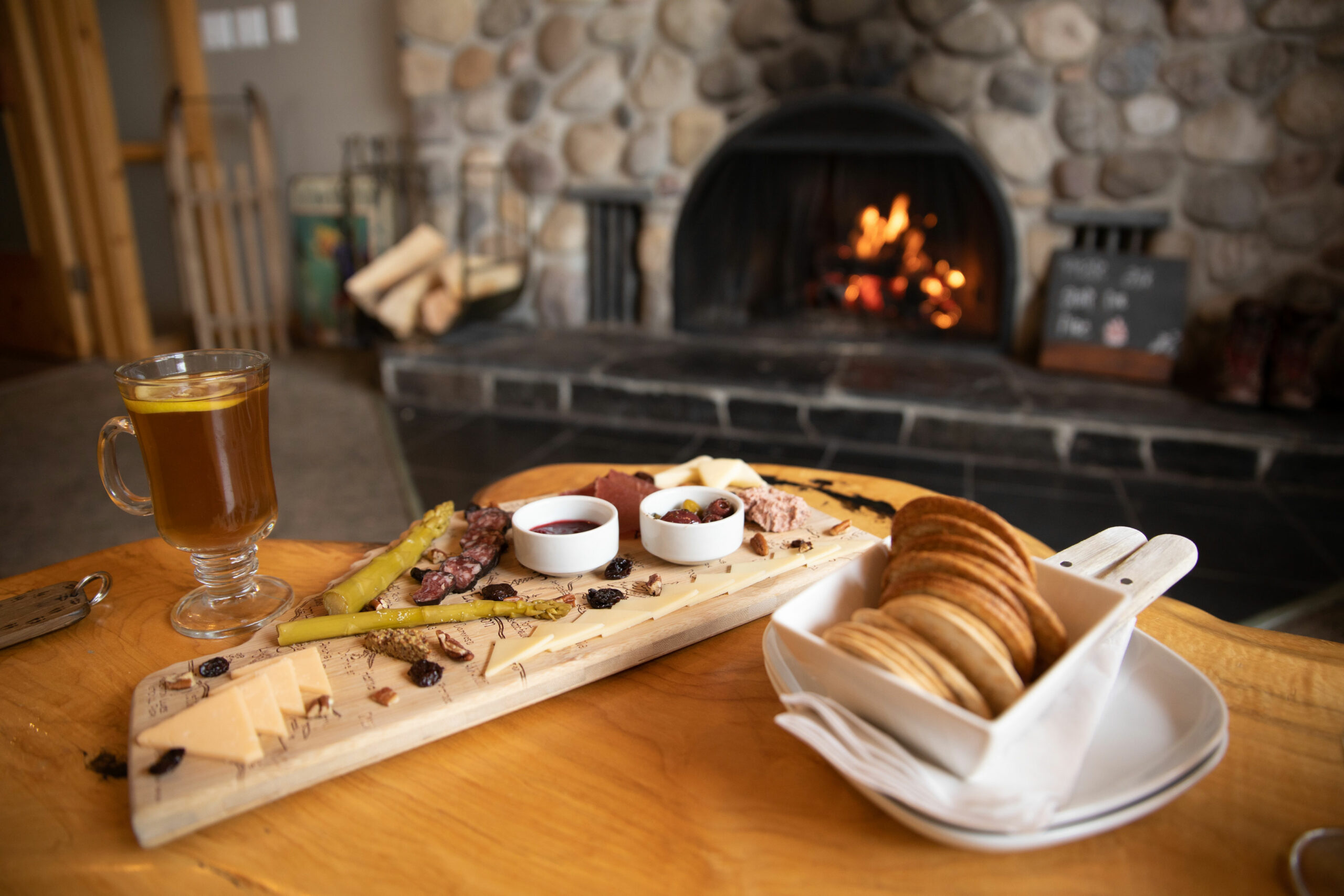 A delicious looking charcuterie in front of a fireplace at Mount Engadine Lodge.