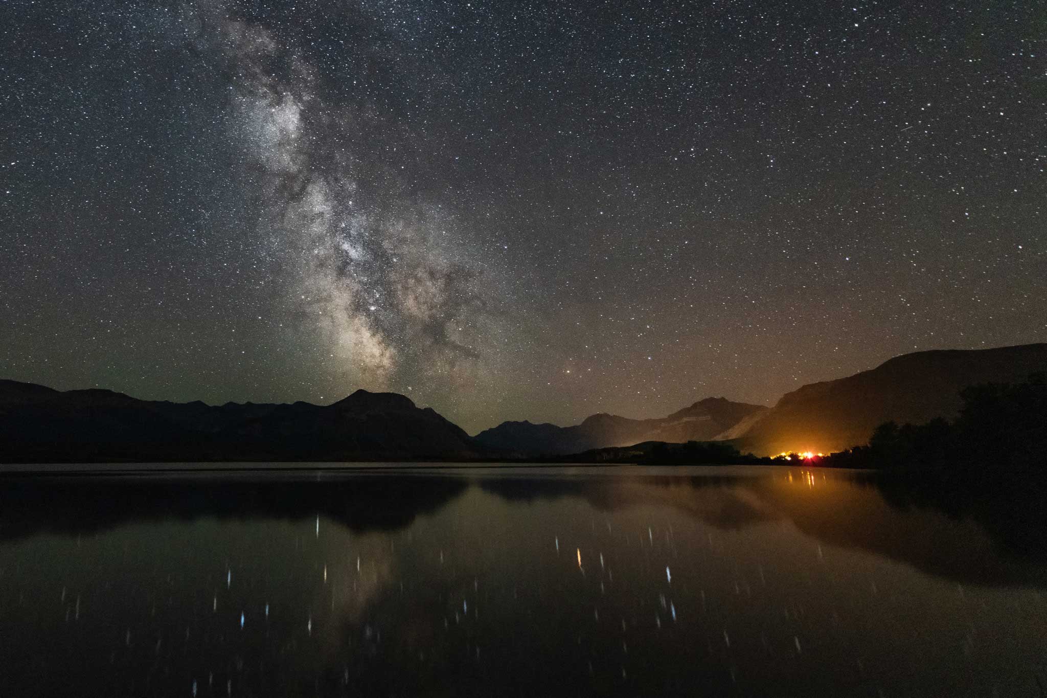A view of the Milky Way over a mountain-ringed lake in Waterton Lakes National Park.
