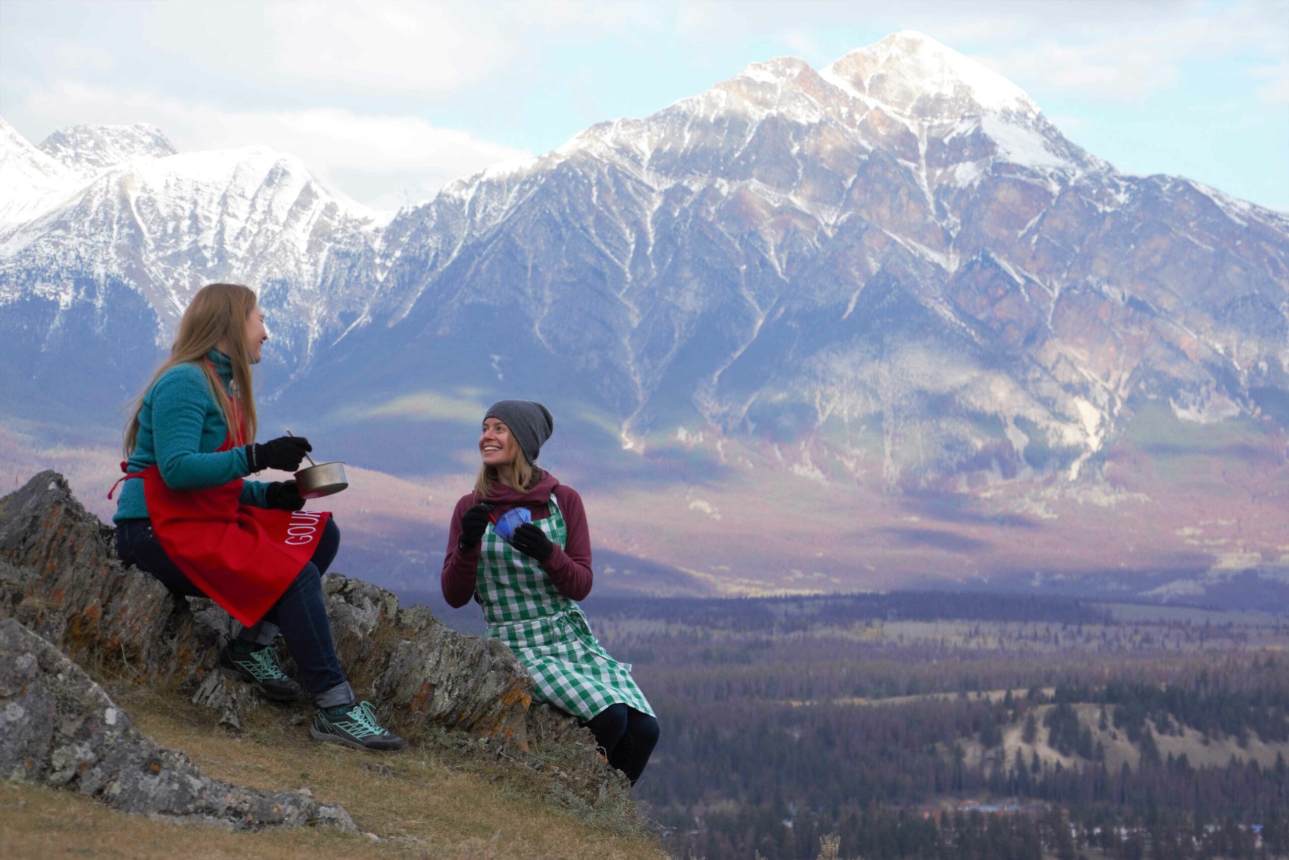 Two people on a mountain top enjoying the Peak Nik tour from Jasper Food Tours