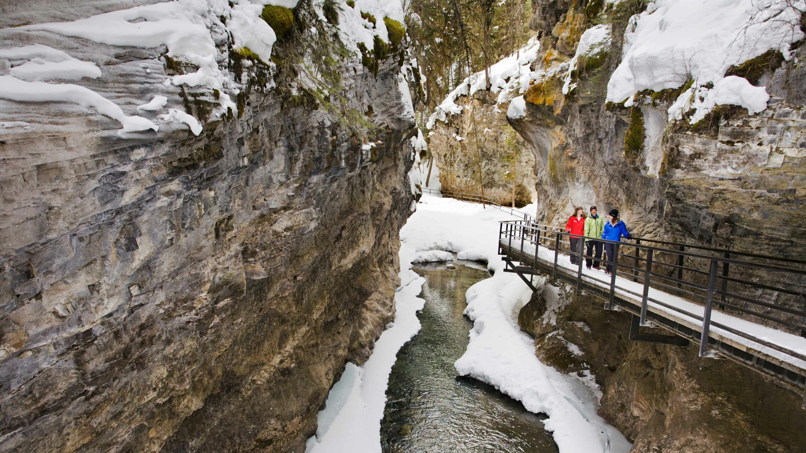 People walk along the catwalk inside Johnson Canyon. This is one of our favourite winter activities.