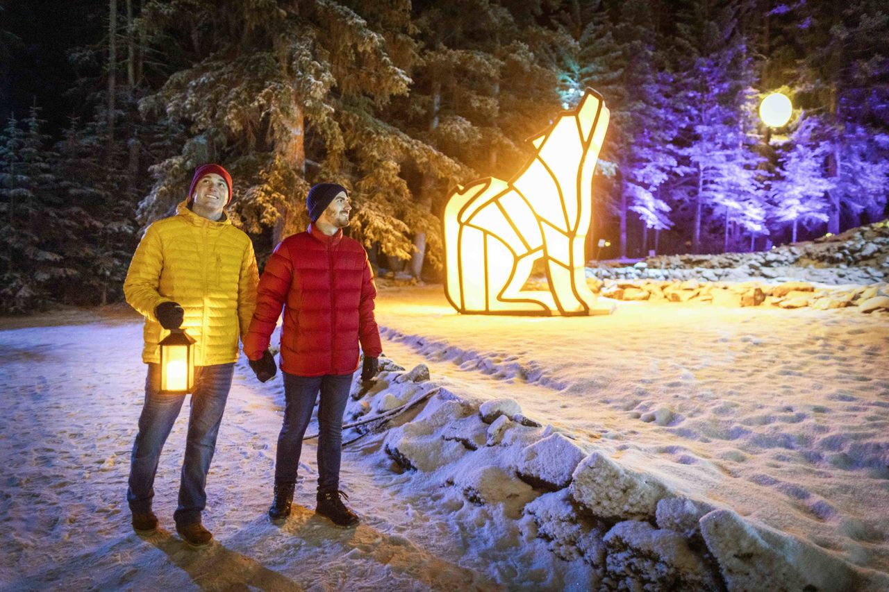 A couple holds hands while exploring "In Search of Christmas Spirit" in Banff as part of some holiday fun.