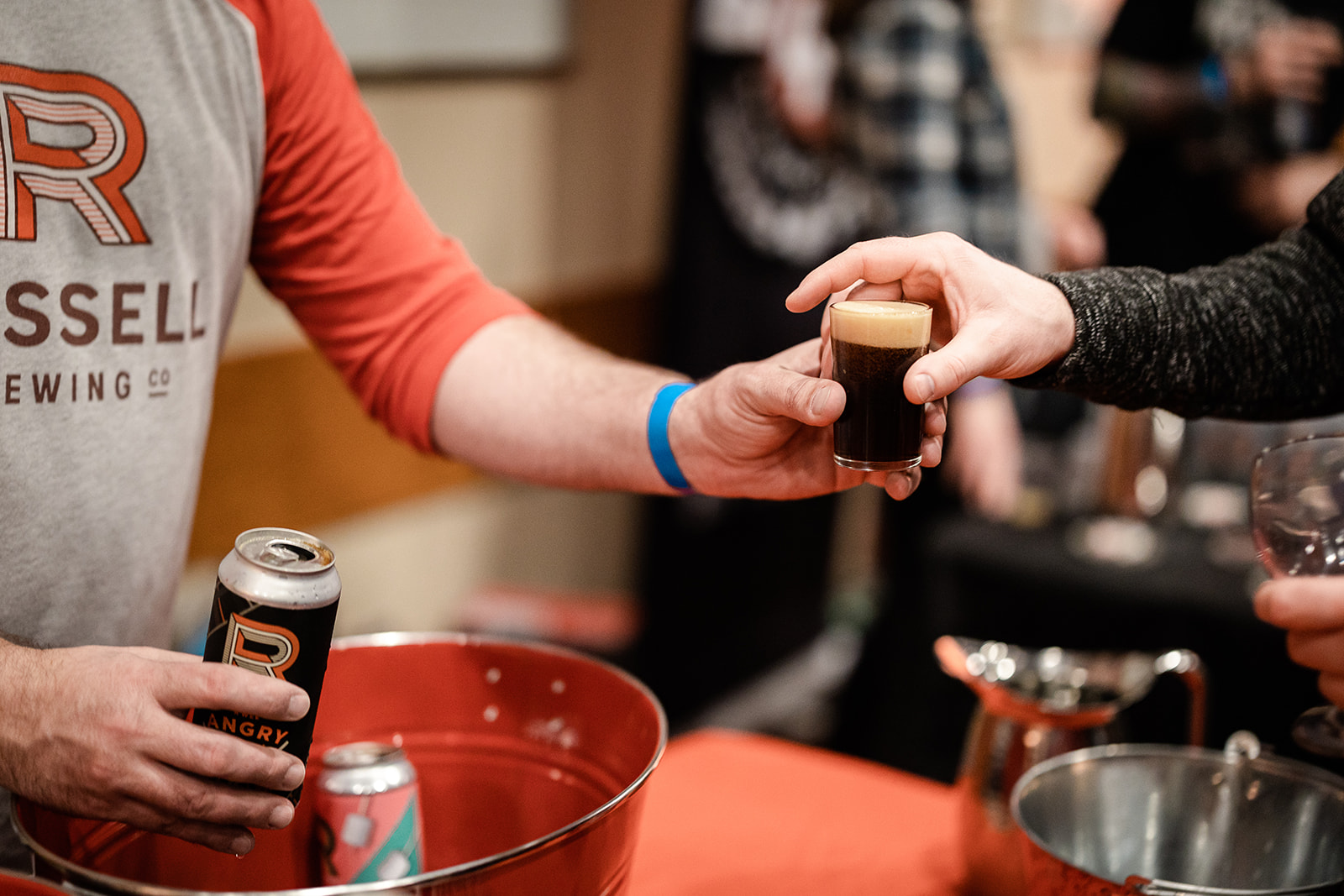 A bartender serves a sample of dark beer at Whisky, Wine & Hops, an event celebrating Jasper in January.