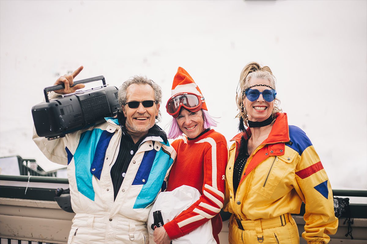 Skiers dress up for the Retro Day and Party at Marmot Basin with a boombox and vintage clothing.