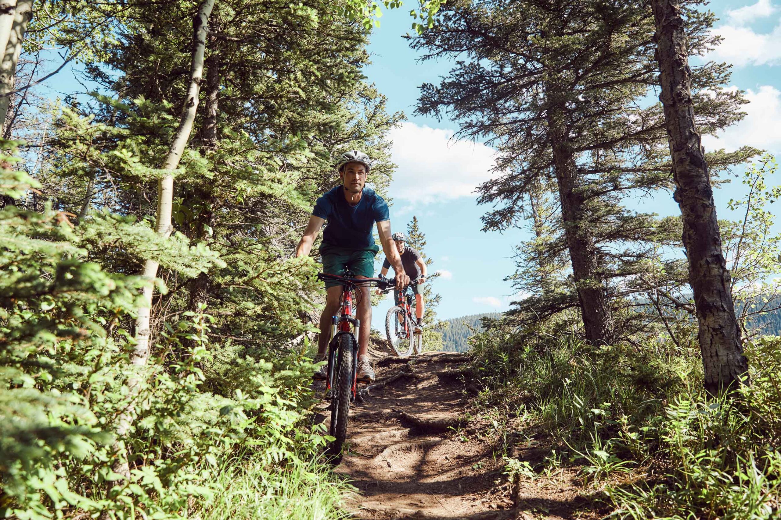 Biking is a fast way to explore the trails, keep an eye out for slower trail users and be prepared to communicate the best way to safely pass on the trail. Photo by Travel Alberta / Colin Way