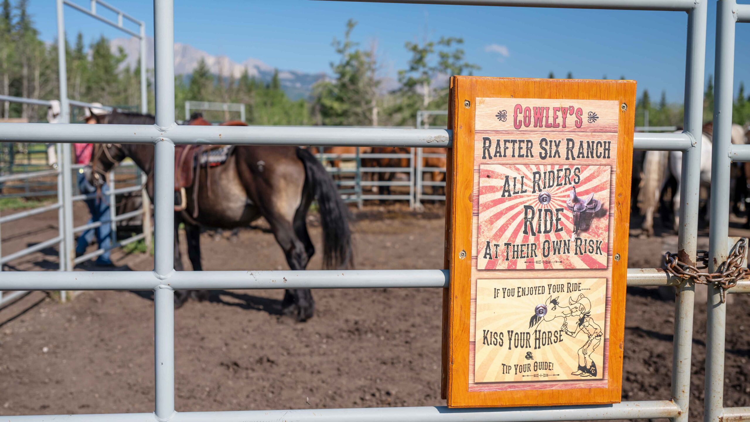 A sign at Cowley's Rafter Six advises people to ride at their own risk and kiss their horses. 