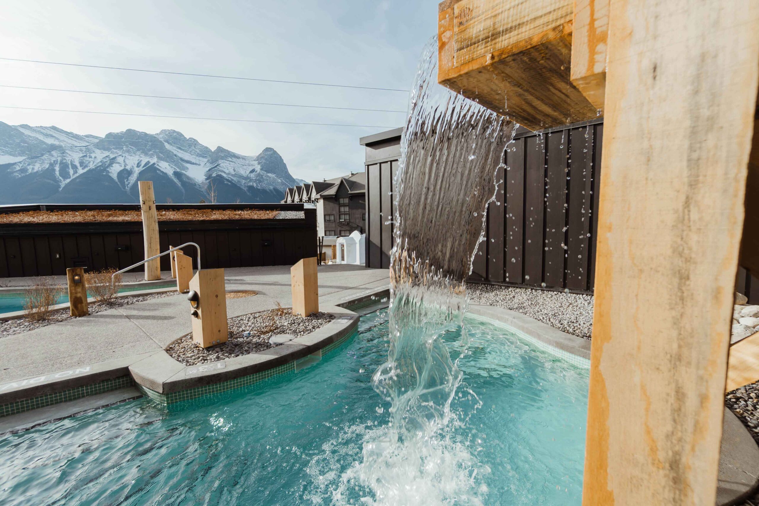 The cold plunge pool has a waterfall and mountain views at Everwild Spa in Canmore