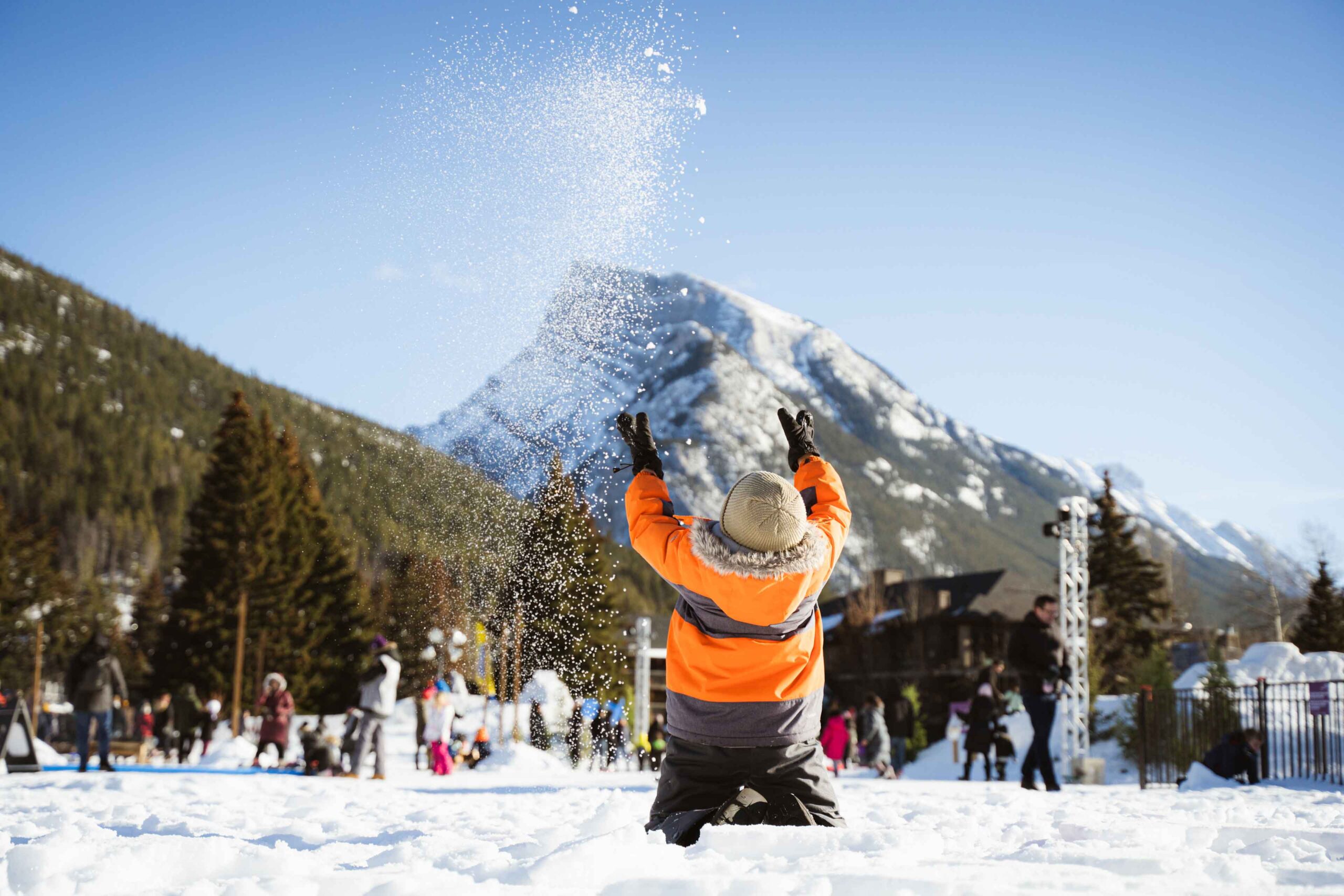 A kid throws snow in the air at the Play Zone for Banff SnowDays