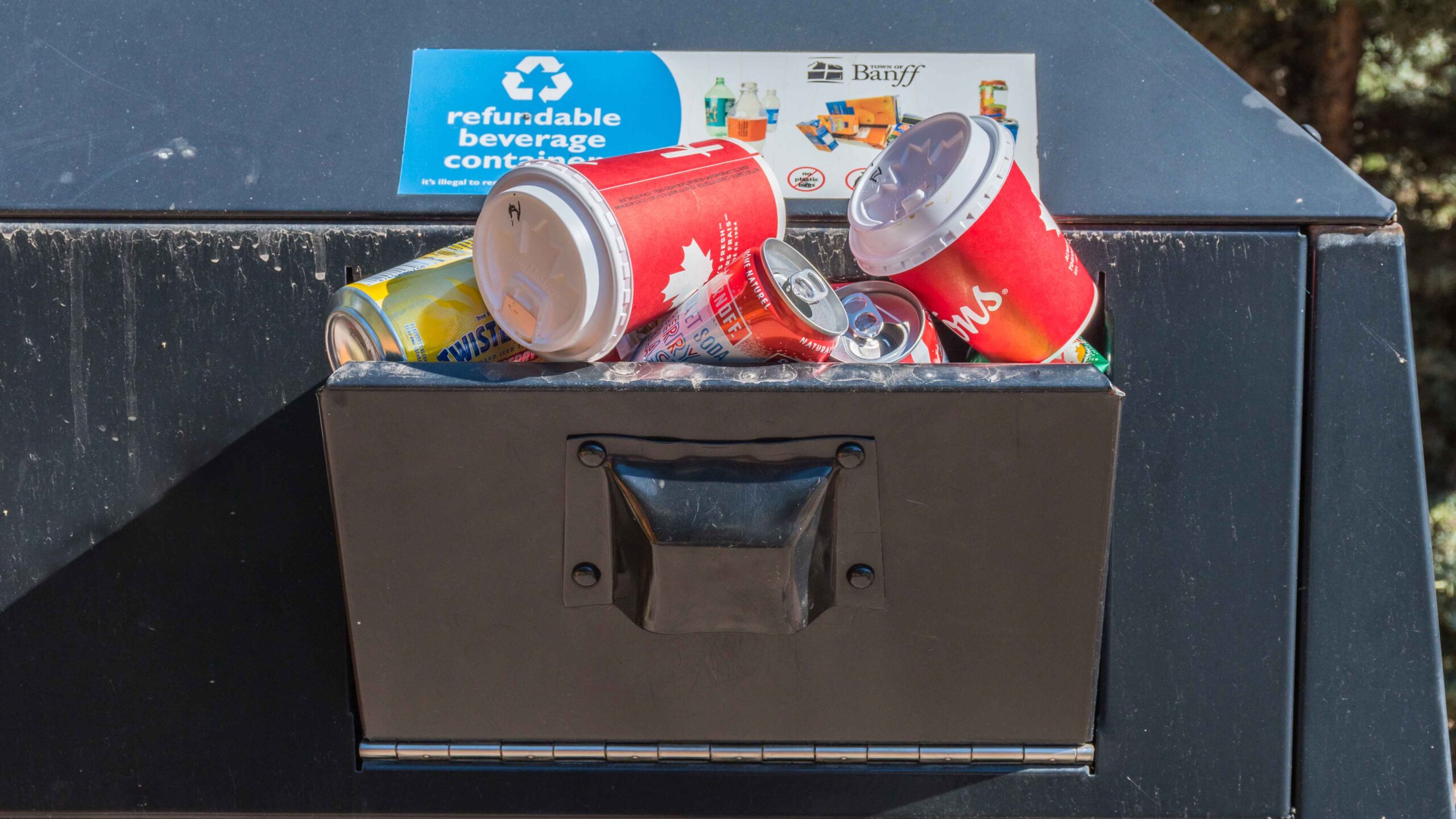 Garbage piles out of a garbage bin in Banff