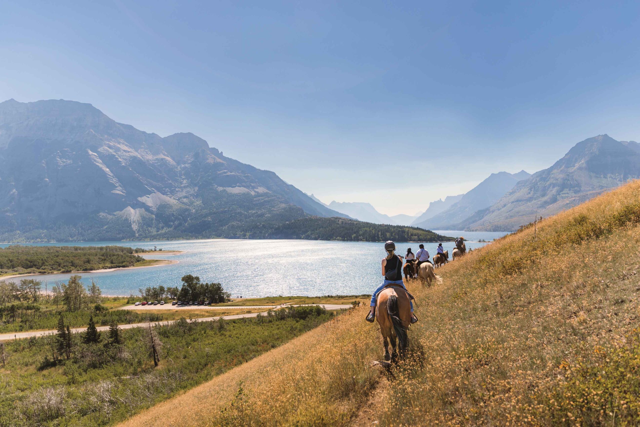 People enjoy a trail ride with Alpine Stables in Waterton Lakes National Park