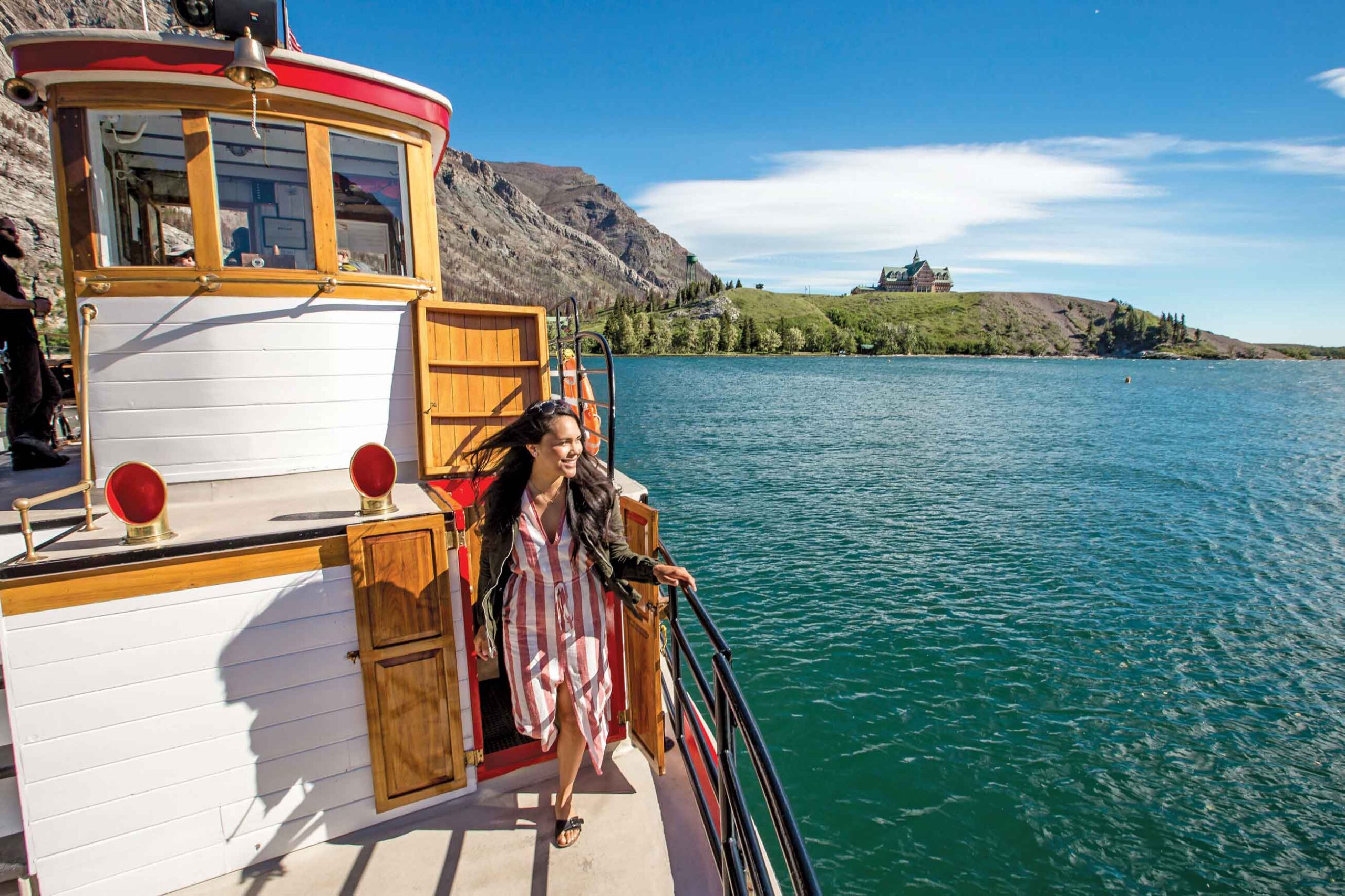 A woman enjoys the sunshine on a Waterton Lakes Shoreline Cruise