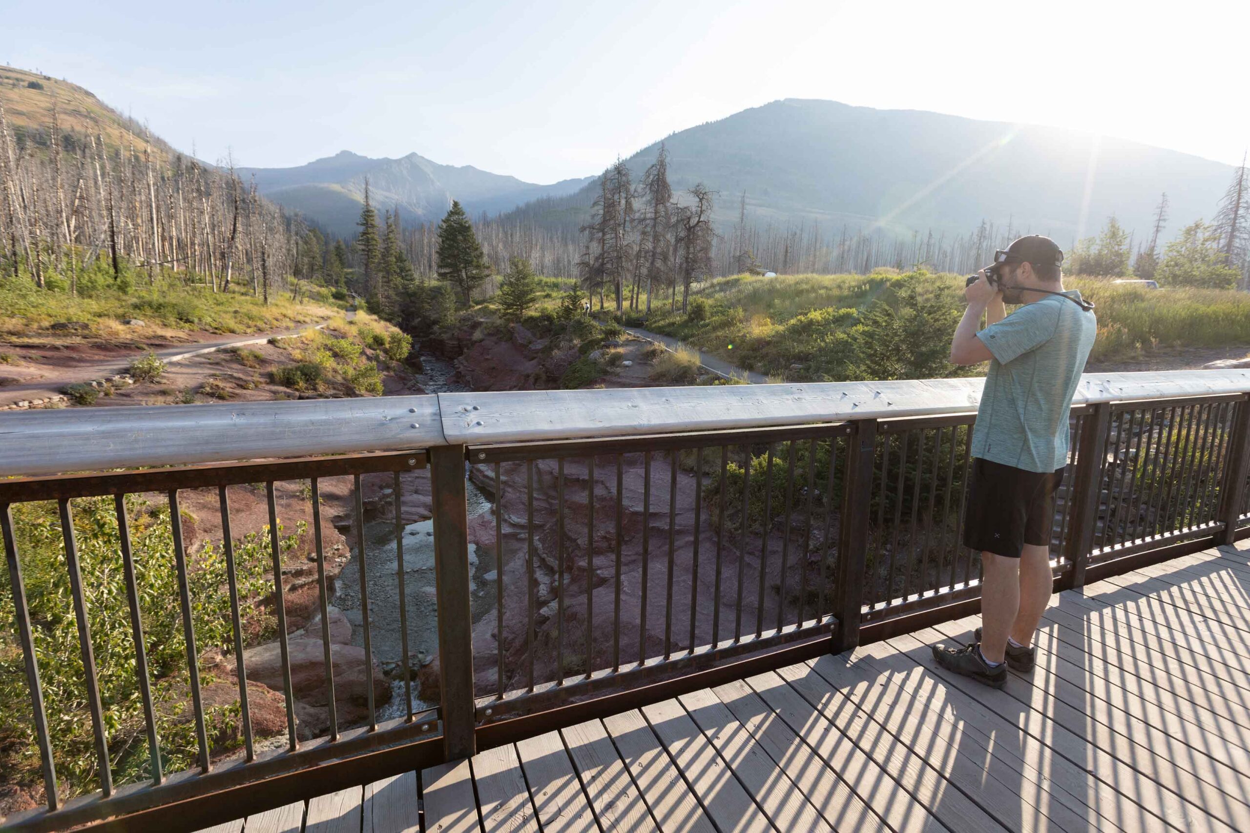 A photographer takes a picture of Redrock Canyon in Waterton Lakes National Park