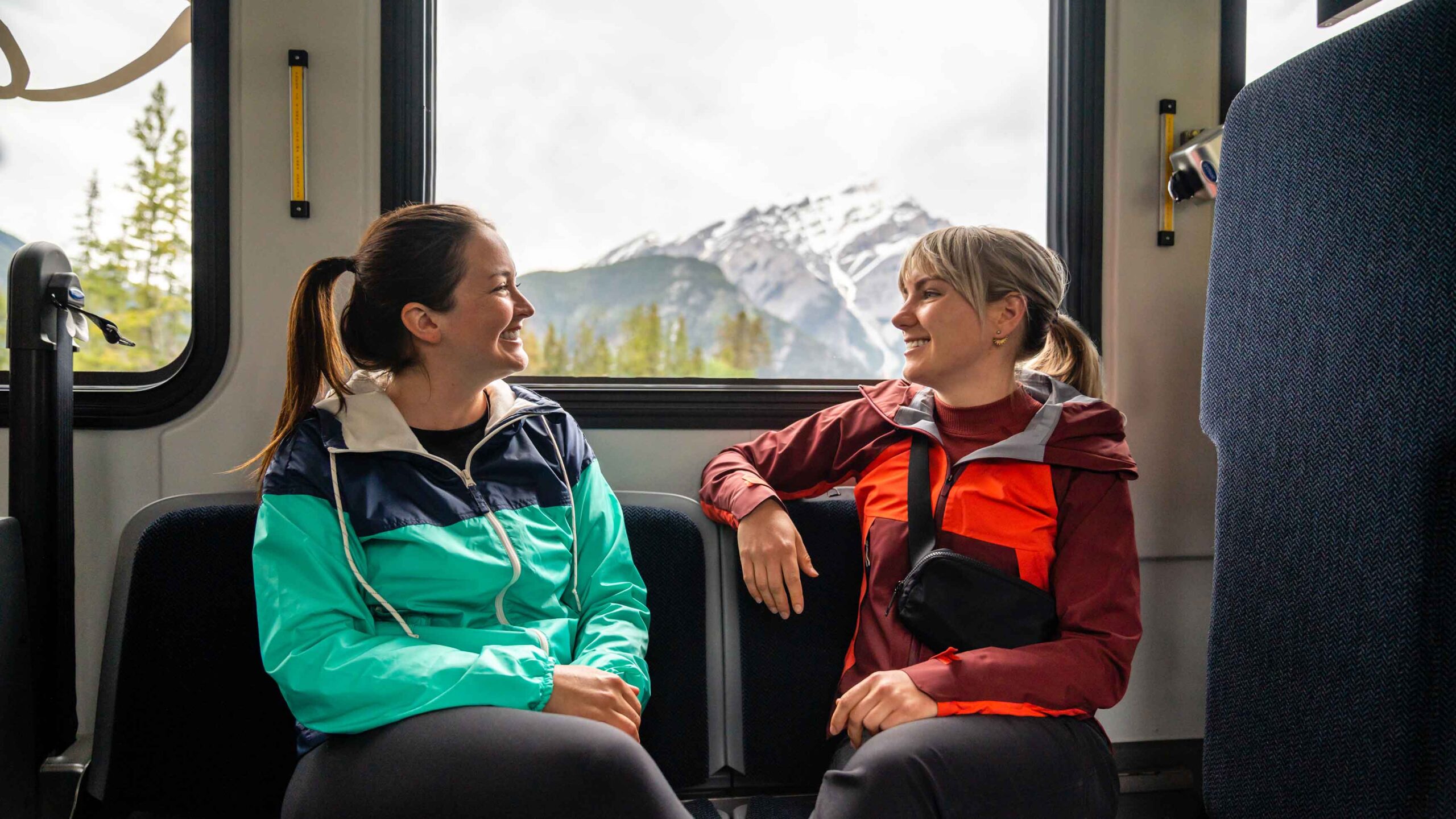 Two people take ROAM Transit to get around Banff
